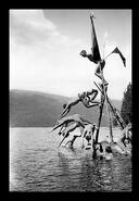 Boy Scouts diving at camp from a hand made structure in the water