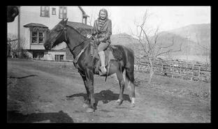 Winnie Hunter riding a horse at the John Irvine's property, Oyama