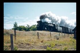Steam train on Kelowna-Vernon line, with head of steam
