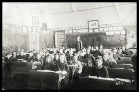 Kenneth Massie amongst a classroom of children and a teacher