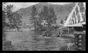 Men clearing a log jam at the bridge in Kettle River, ca. 1915