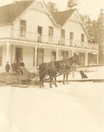 Horse drawn sleigh in front of old Creston Hotel