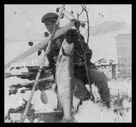 Man with a freshly caught fish from Okanagan Lake