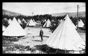 Frederick Charles Strongitharm standing by the bell tents in Vernon Internment Camp