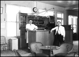 Two men standing at the Coldstream Hotel bar