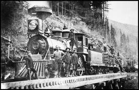 Shuswap and Okanagan Railway construction crew standing with locomotive on a bridge at Mara Lake