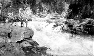 Two unidentified men on rock at Shuswap Falls
