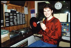 DJ playing records at CKCR, Revelstoke's radio station