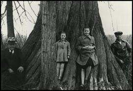 Betty, Amy and Andy Rauma beside tree