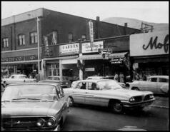 Street scene on the 1300 block of Bay Avenue showing businesses on the east side of street, late 1960s
