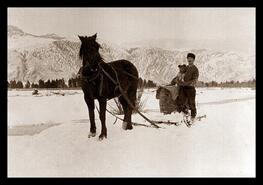 Quants hauling water in the snow on a sled