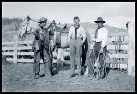 Group of cowboys in corral