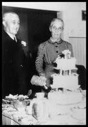 Mr. and Mrs. Barney Peters cutting cake at 69th wedding anniversary