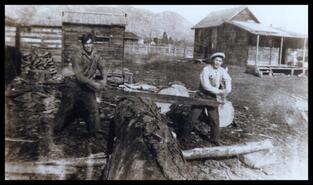 Tim and Jim Voght sawing log at ranch