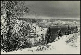 [View of lake from snow covered cliffs]