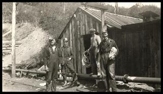 George Sherriff and Bob Clare in group of miners in front of Wilson Tunnel fire bosses cabin at Blakeburn, Coalmont 
