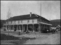 Men standing on the porch of the Enderby Hotel