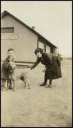 [Lillian Estabrook with small boy and dog]