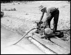 Bill Yurik at pump to water down the slash burn at Kinbasket Lake during construction of Big Bend Highway