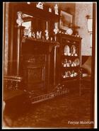 Cast iron fireplace and shelves of knick-knacks