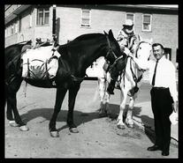 Jack Goddard and unidentified man with two horses at parade