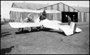 H.R. Denison in a bi-plane