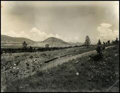 [View of the outskirts of Penticton with pipe along the road]