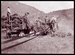 Postcard of Mildred Scatchard and others working a thresher