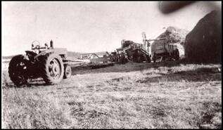 Tractor-powered threshing machine at Steffens place