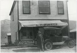 Mrs. E.M. Taylor in front of A.E. Fisher's store in Invermere