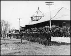 Members of the 11th Canadian Mounted Rifles regiment lined up at the Vernon C.P.R. train station