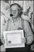 Hope Brewer with pipe holding certificate