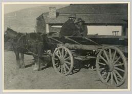 Two aboriginal people on wagon, ca. 1929