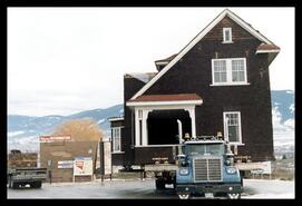Watson house on a flatbed truck at the top of Mission Hill