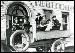 Maunder, Hogan, Laughten and Downs families in a truck at Victoria Hotel