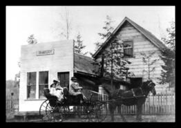Harper family in carriage in front bakery at the end of Alexander Avenue