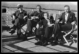Four unidentified men seated on a boat