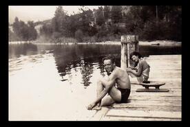 Nora McGrath and unidentified boy sitting on the wharf at Okanagan Centre