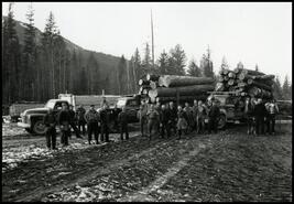 J.D. Churchill crew in front of loaded logging trucks