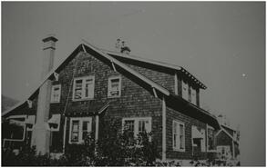 M.J. Finlayson home with two unidentified persons on the roof