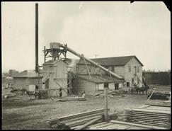 Side view of Kelowna Sawmill Co. Ltd. and surrounding lumber piles