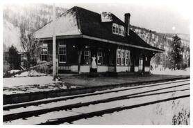 Mrs. Seal in doorway of Dot railway station (with post office, 1917-1931) on the Kettle Valley Railway