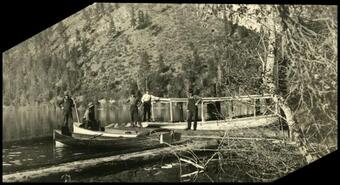 Group of men with three boats at Christina Lake