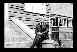 Man (Dr. Uchida?) sitting on a stairway at Sanatorium, New Denver