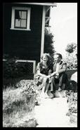 Axel and Daisy (Malm) Gronquist sitting on steps of house