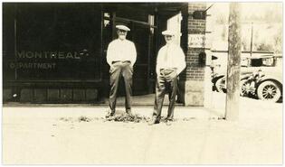 Two men in front of Bank of Montreal in Princeton Hotel building