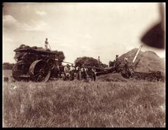 Men with steam tractor and threshing equipment