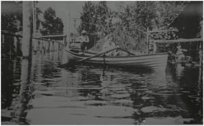 Mary Dillobough in boat on Riverside Road during 1928 flood