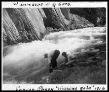 W. Lambert and George Love gold panning on Canyon Creek