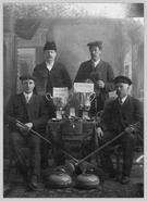 Group photograph of curling "Merchants Cup" trophy winners